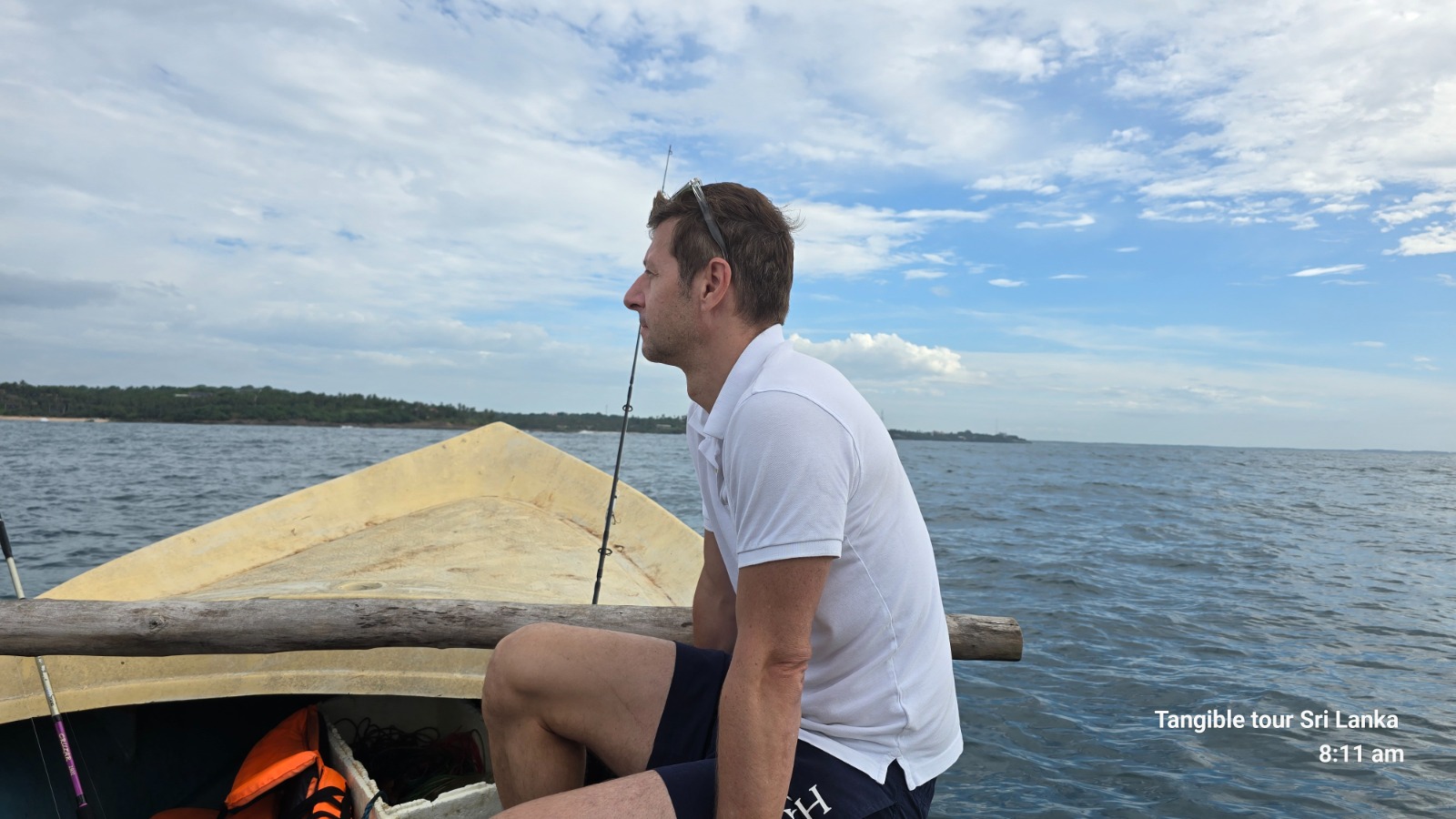 Angler watching the line from the bow of an outrigger boat
